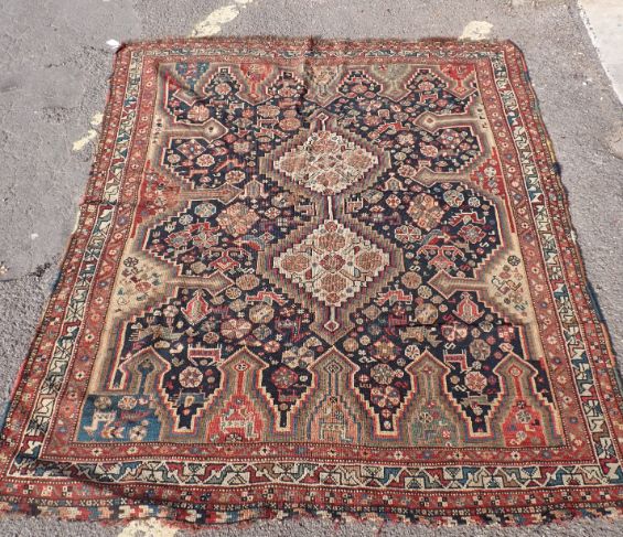 A PERSIAN STYLE RUG WITH STYLISED ANIMALS AND PLANT DECORATION