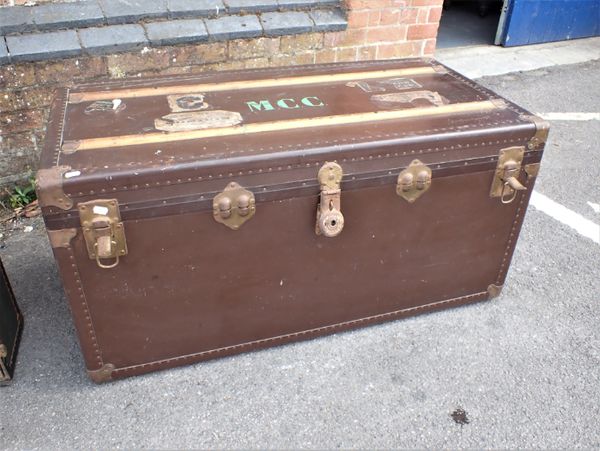 AN EARLY 20TH CENTURY TRAVELLING TRUNK, WITH LABELS