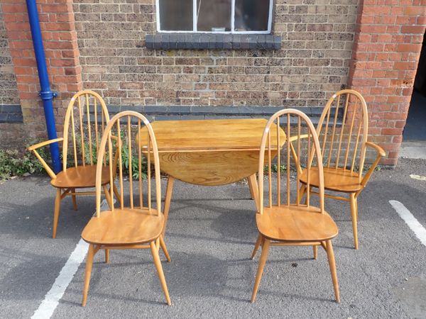 AN ERCOL DROP-LEAF DINING TABLE AND FOUR CHAIRS