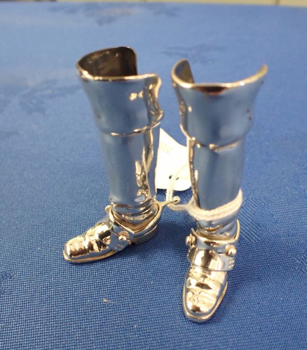 A PAIR OF SILVER RIDING BOOTS