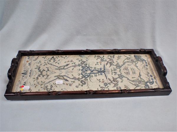 A CHINESE EMBROIDERY FRAGMENT UNDER GLASS, AS A TRAY