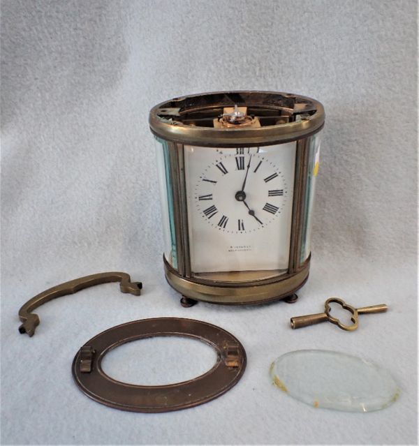 AN OVAL-CASED CARRIAGE CLOCK