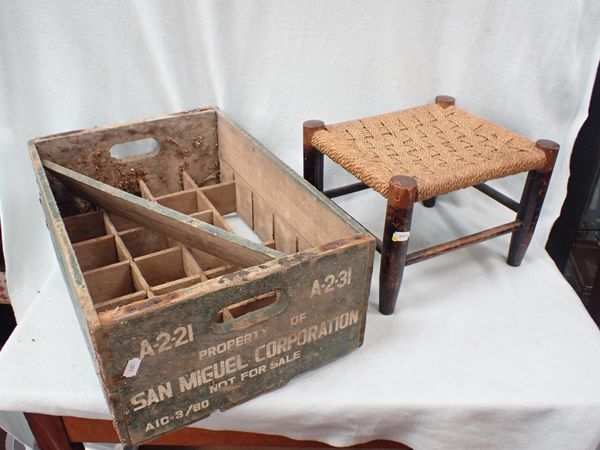A VINTAGE SAN MIGUEL BOTTLE CRATE AND A WOODEN STOOL