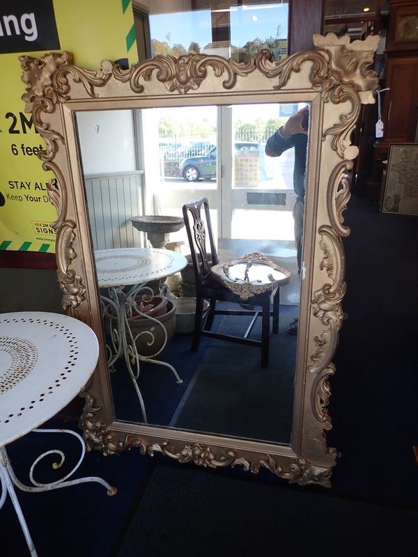 A LARGE GILTWOOD AND COMPOSITION MIRROR