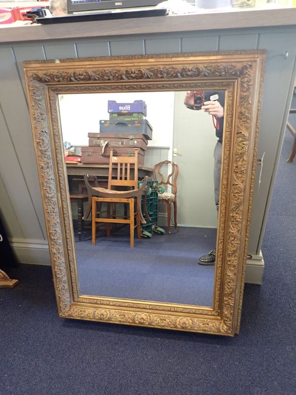 A GILTWOOD AND COMPOSITION MIRROR