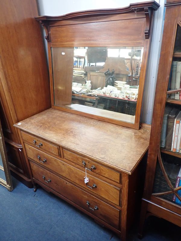 AN OAK CHEST OF DRAWERS