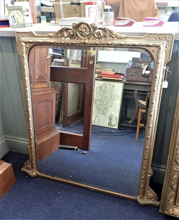 A GILTWOOD AND COMPOSITION OVERMANTEL MIRROR