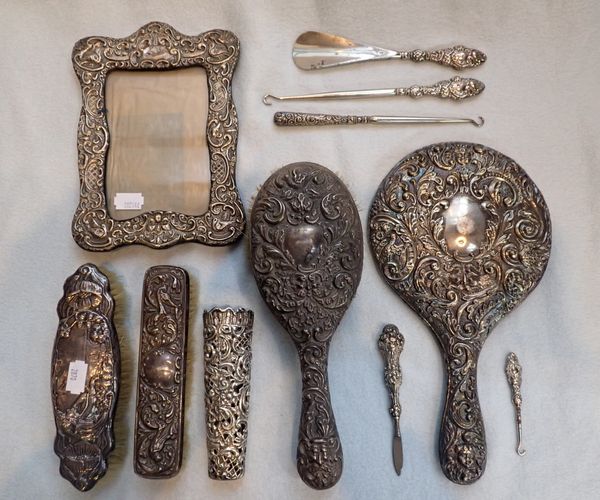 A COLLECTION OF REPOUSSE SILVER DRESSING TABLE ITEMS