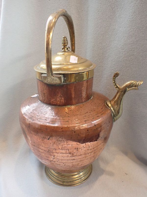 A LARGE COPPER AND BRASS KETTLE