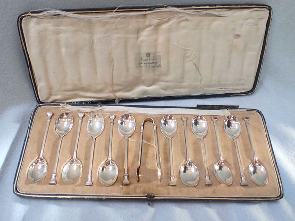 A SET OF TWELVE SILVER TEASPOONS AND TONGS