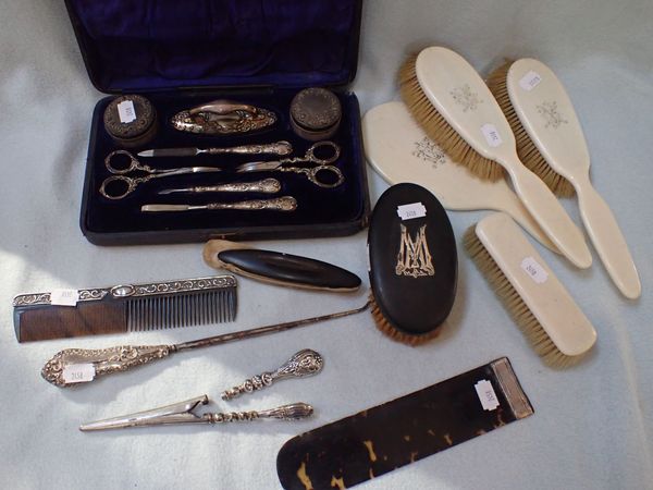 A CASED SILVER-MOUNTED MANICURE SET, A MONOGRAMMED BRUSH