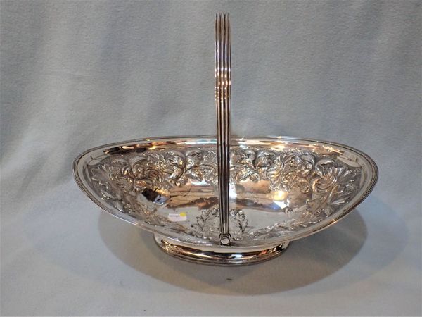 AN UNMARKED WHITE METAL SWING-HANDLED DISH