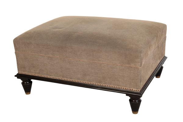 AN EBONISED AND UPHOLSTERED LOW STOOL,