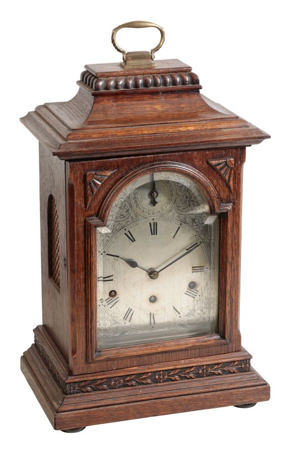 A LATE VICTORIAN OAK CASED BRACKET CLOCK