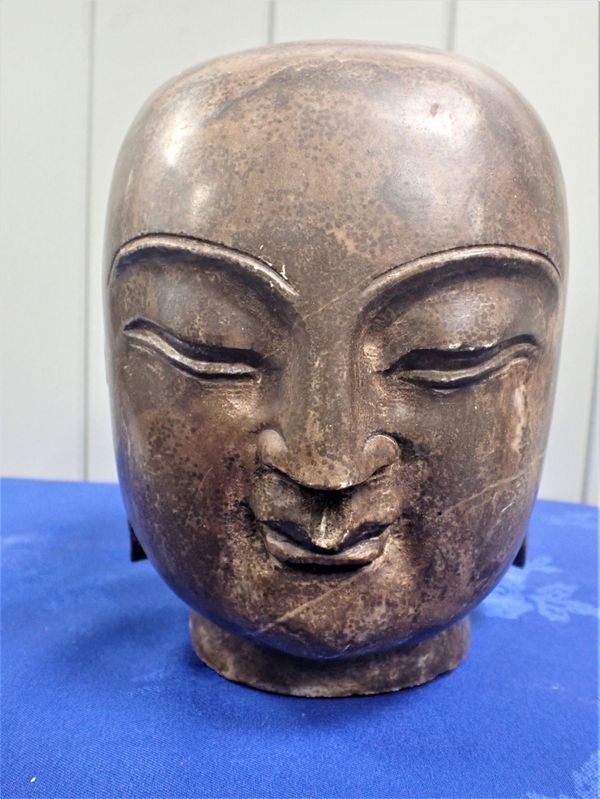 A LARGE ORIENTAL CARVED SOLID GRANITE HEAD OF BUDDHA