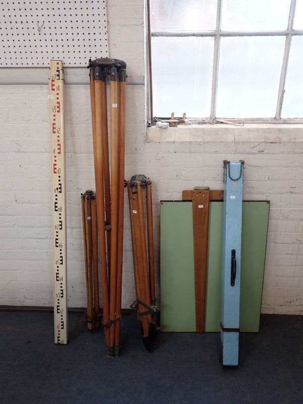A VINTAGE DRAWING BOARD WITH THREE WOODEN TRIPODS