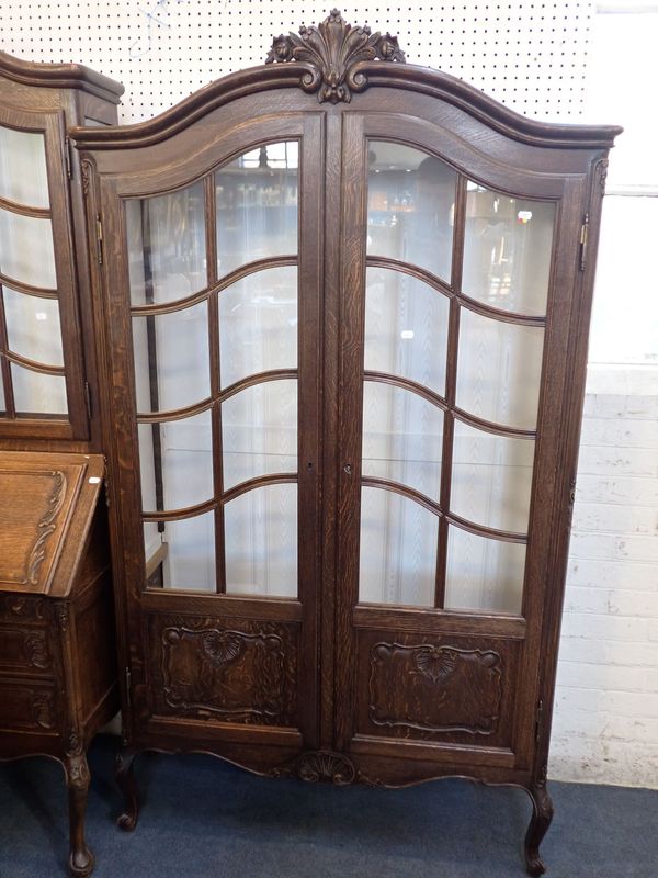 A FRENCH PROVINCIAL STYLE CARVED OAK DISPLAY CABINET