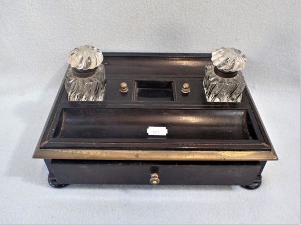 A WOODEN DESK STAND WITH GLASS INKWELLS