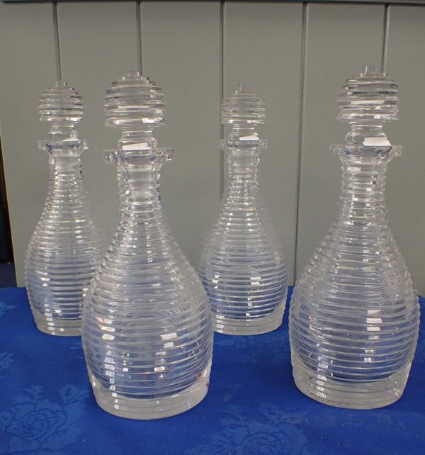 FOUR REGENCY CUT GLASS DECANTERS, OF RIBBED DESIGN