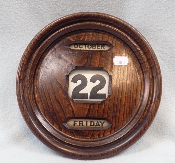 A ROUND HANGING PERPETUAL CALENDAR