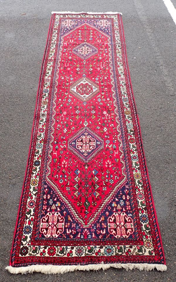 A RED GROUND PERSIAN DESIGN RUNNER