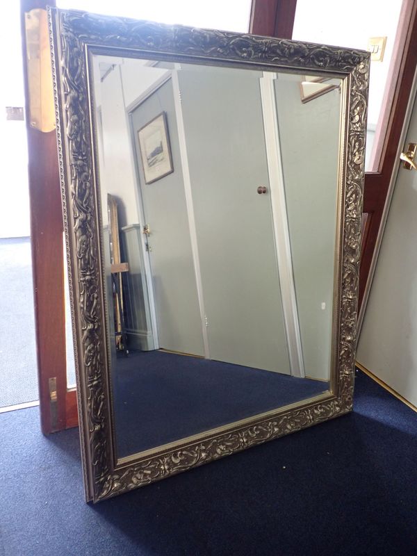 A REPRODUCTION WALL MIRROR WITH SILVERED FRAME