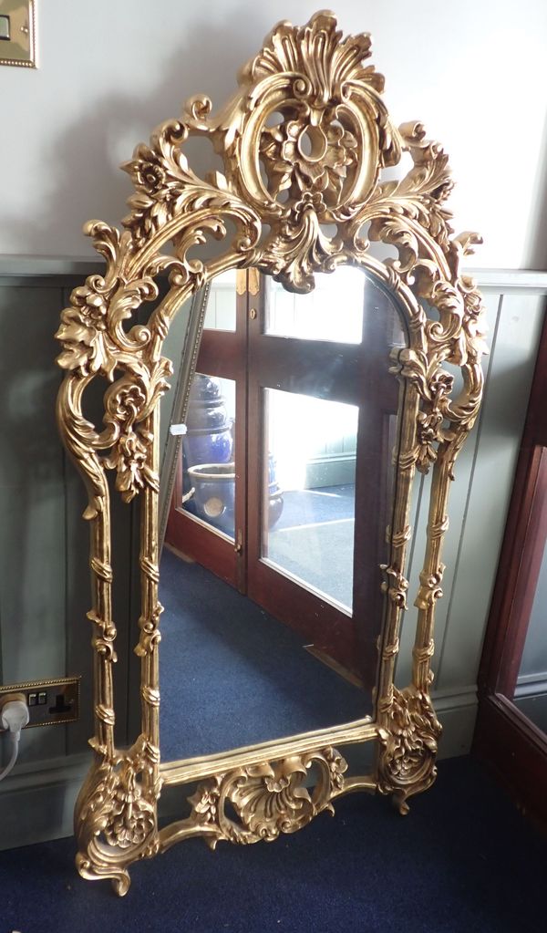 A MODERN CAST COMPOSTITION GILT FRAMED MIRROR