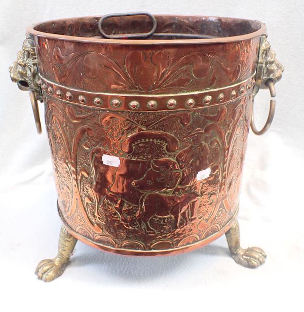 AN EMBOSSED COPPER LOG BUCKET WITH LION HEADS