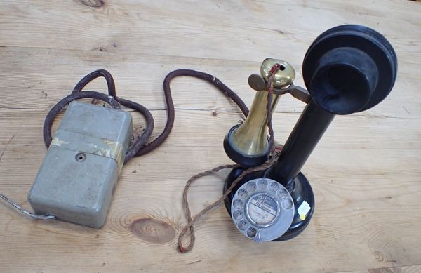 A VINTAGE BRASS AND JAPANNED 'CANDLESTICK' TELEPHONE