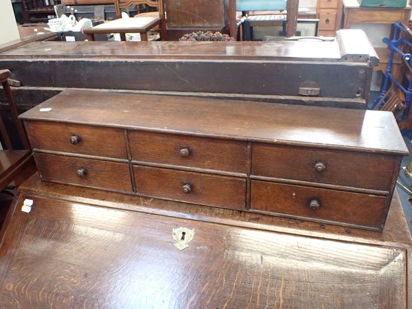 A 19TH CENTURY OAK TABLE-TOP BANK OF SIX DRAWERS