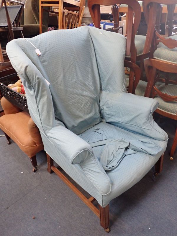 A GEORGE III STYLE WING ARMCHAIR