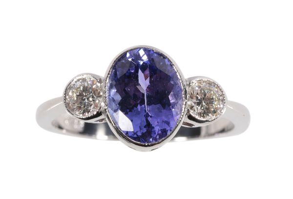 A THREE STONE TANZANITE AND DIAMOND RING