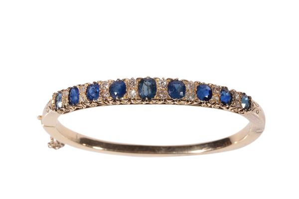 A SAPPHIRE AND DIAMOND HINGED BANGLE