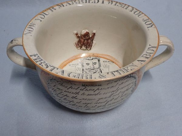 A 19TH CENTURY TWO-HANDLED 'MARRIAGE' CHAMBER POT