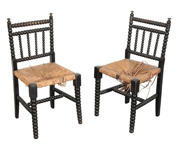 A PAIR OF VICTORIAN EBONISED BOBBIN FRAME CHAIRS