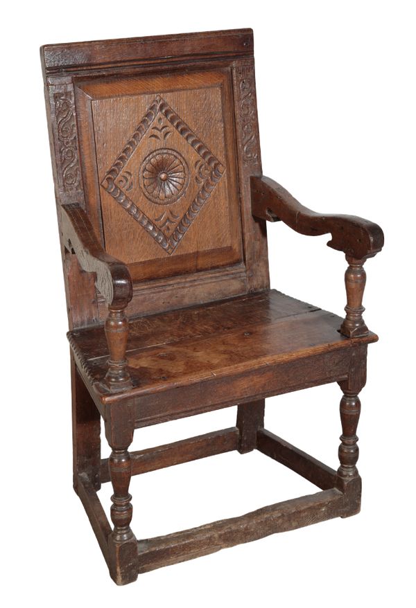 A CHARLES II OAK ARMCHAIR