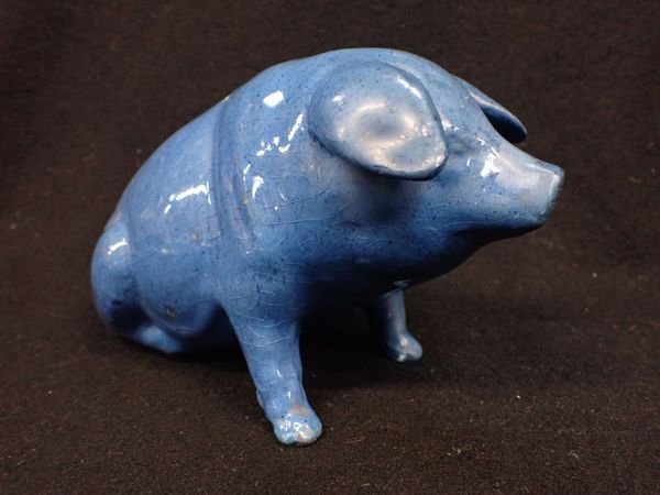 AN EWENNY POTTERY PIG, BLUE GLAZED