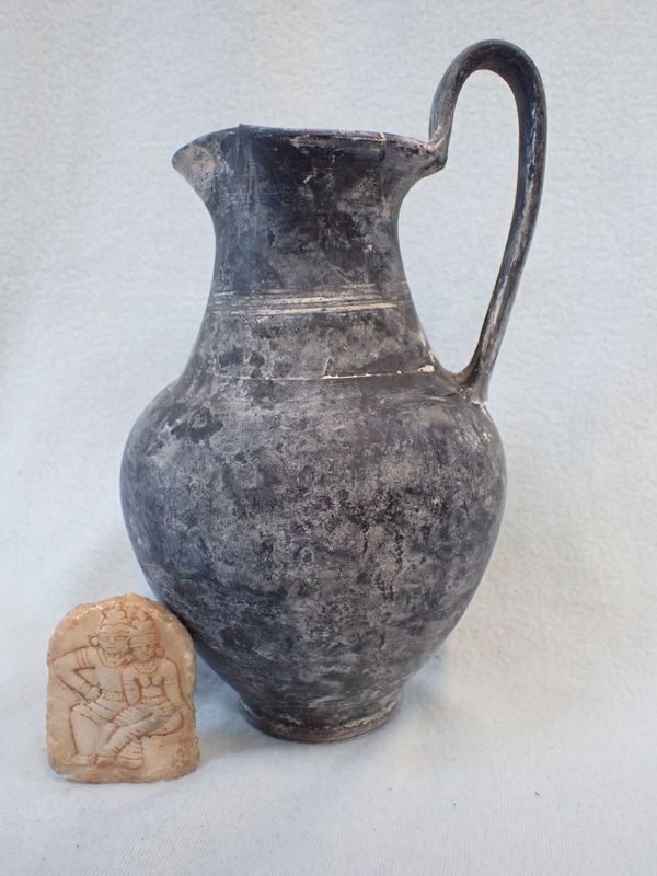 A ROMAN STYLE BLACK POTTERY JUG