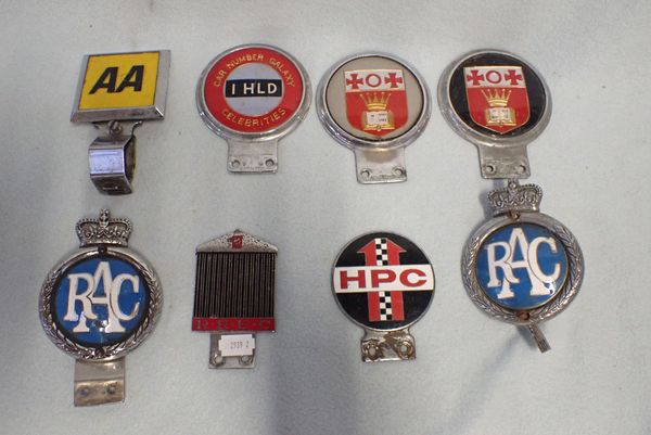 A COLLECTION OF CAR BADGES