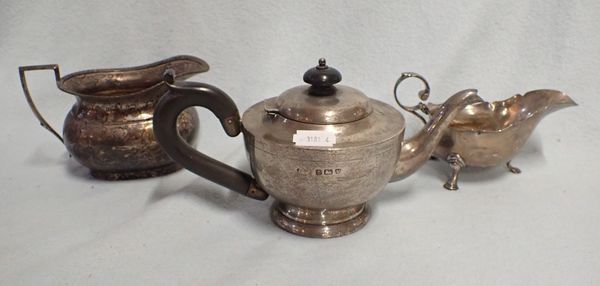 A SILVER TEAPOT, A MILK JUG, AND A SAUCEBOAT