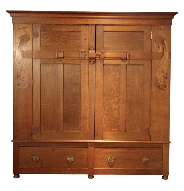 AN ARTS AND CRAFTS STYLE OAK CABINET IN THE MANNER OF WYLIE AND LOCHHEAD, GLASGOW