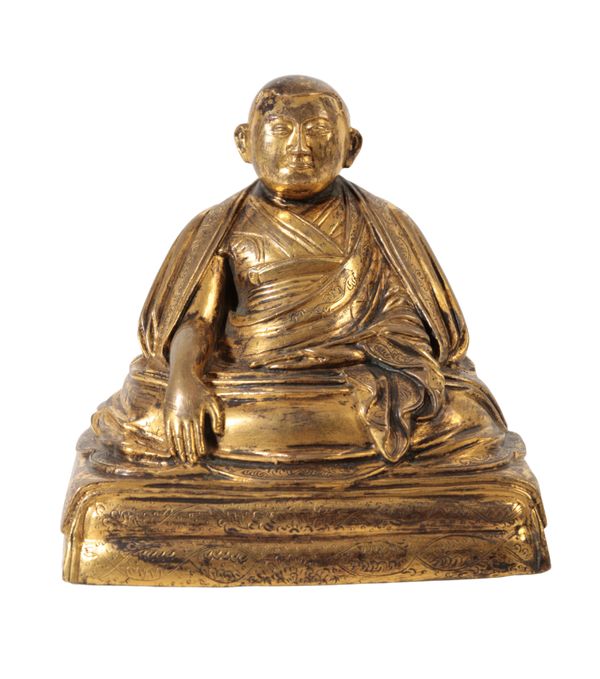 A CHINESE GILT BRONZE OF A MONK
