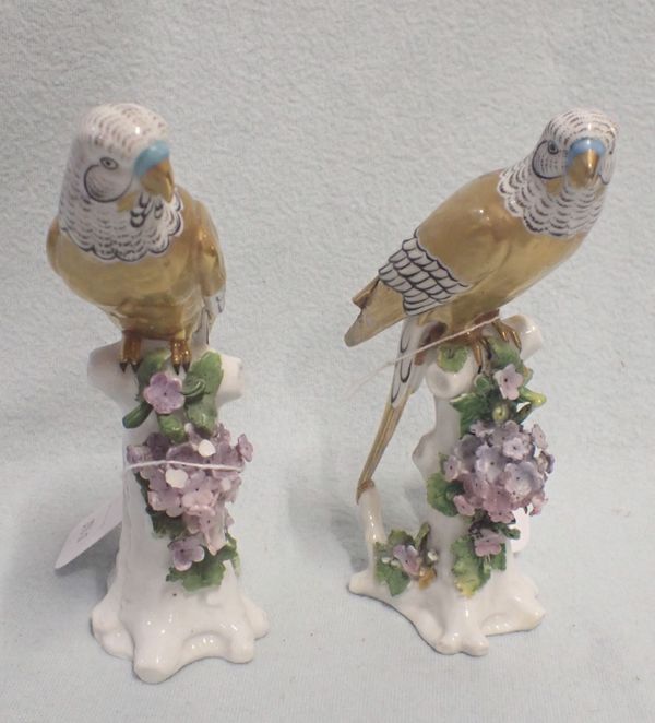 A PAIR OF PORCELAIN BUDGERIGARS WITH GILDED BODIES