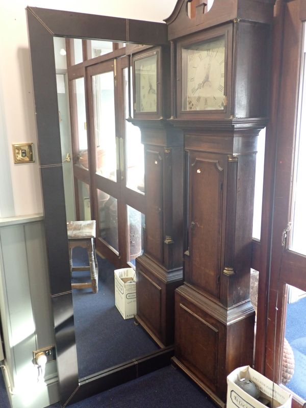 A LARGE MODERN MIRROR WITH LEATHER BOUND FRAME