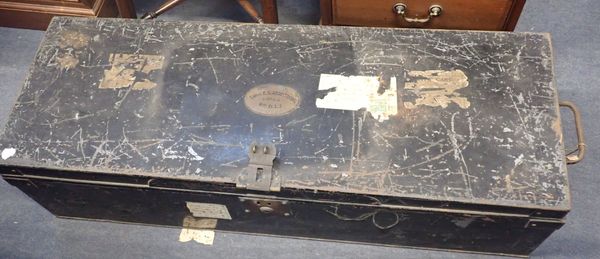 A METAL TRUNK WITH A BRASS NAMEPLATE