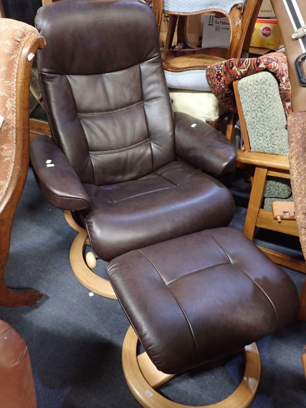 A MODERN SWIVEL EASY CHAIR AND FOOTSTOOL