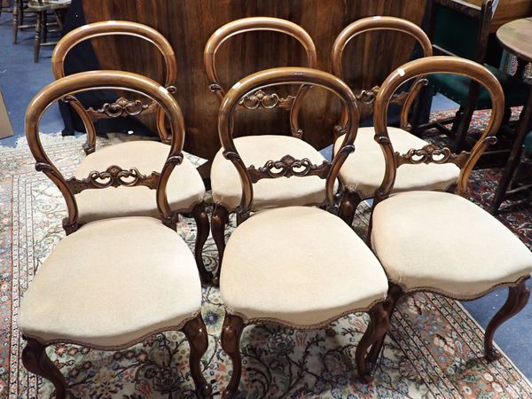 A SET OF SIX VICTORIAN WALNUT BALLOON-BACK DINING CHAIRS