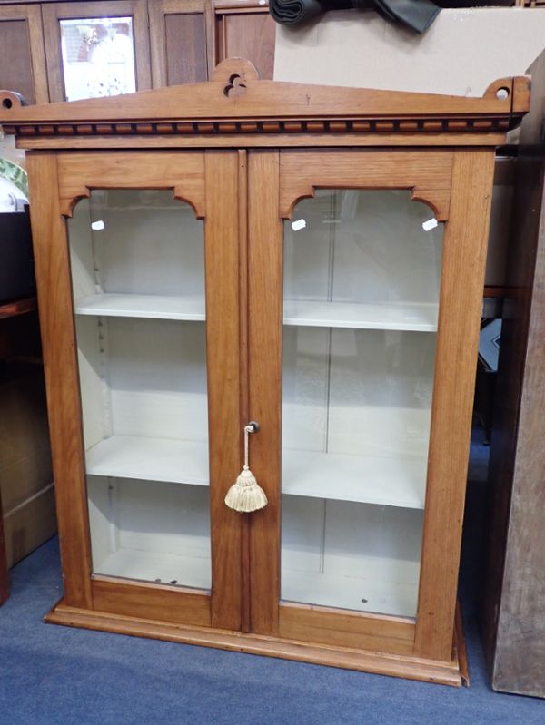 A VICTORIAN GOTHIC GLAZED TWO-DOOR CABINET, WITH TREFOIL PIERCED PEDIMENT