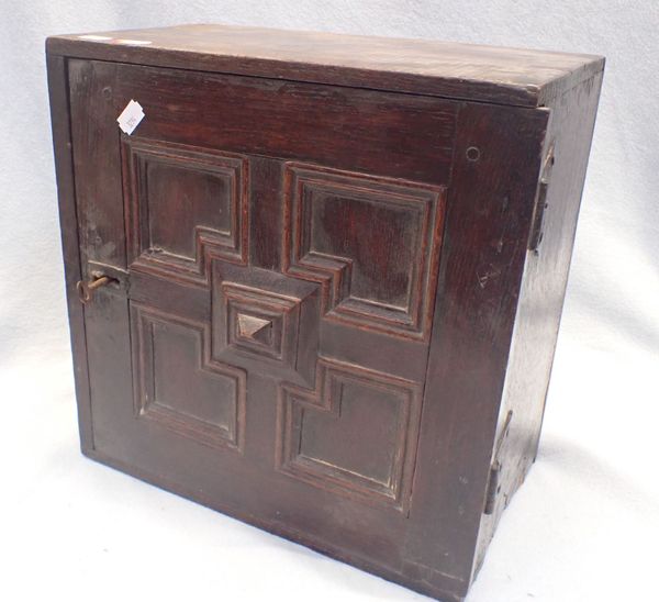 A 17TH CENTURY OAK SPICE CUPBOARD