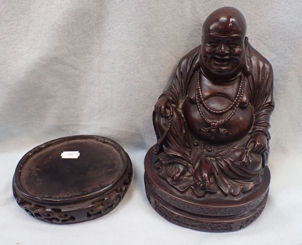 A DECORATIVE PATINATED CAST RESIN BUDDAH